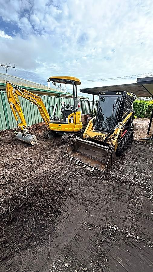 Mini excavator and skid steer on a residential site