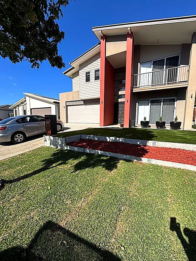 Landscaped front yard with turf and garden beds