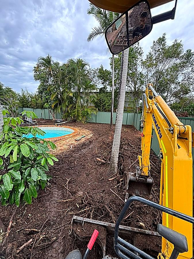 Excavator working around an in-ground pool